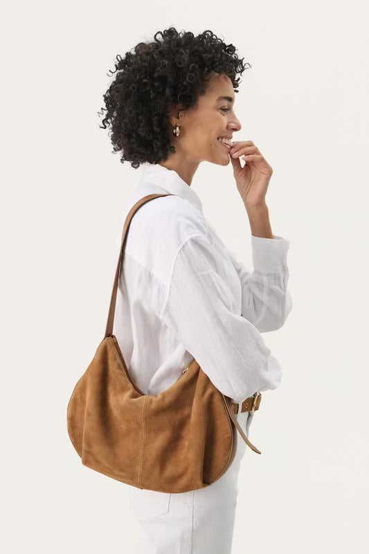 Nevena Bag. Suede shoulder bag. The bag has an adjustable leather strap and zip closure. 
Composition : 100% Suede
Lining: 96% Polyester,4% Elastane
Colour: Toasted Coconut
The Beach House Boutique, Rock, Cornwall. 