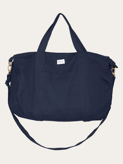 45L duffel bag made from 100% organic cotton canvas. The large main compartment has plenty of space with a zip closure. The duffel bag has a handle and adjustable shoulder straps that can also be detached.

Quality: 100% Organic Cotton
Colour: Navy

The Beach House Boutique, Rock, Cornwall. 