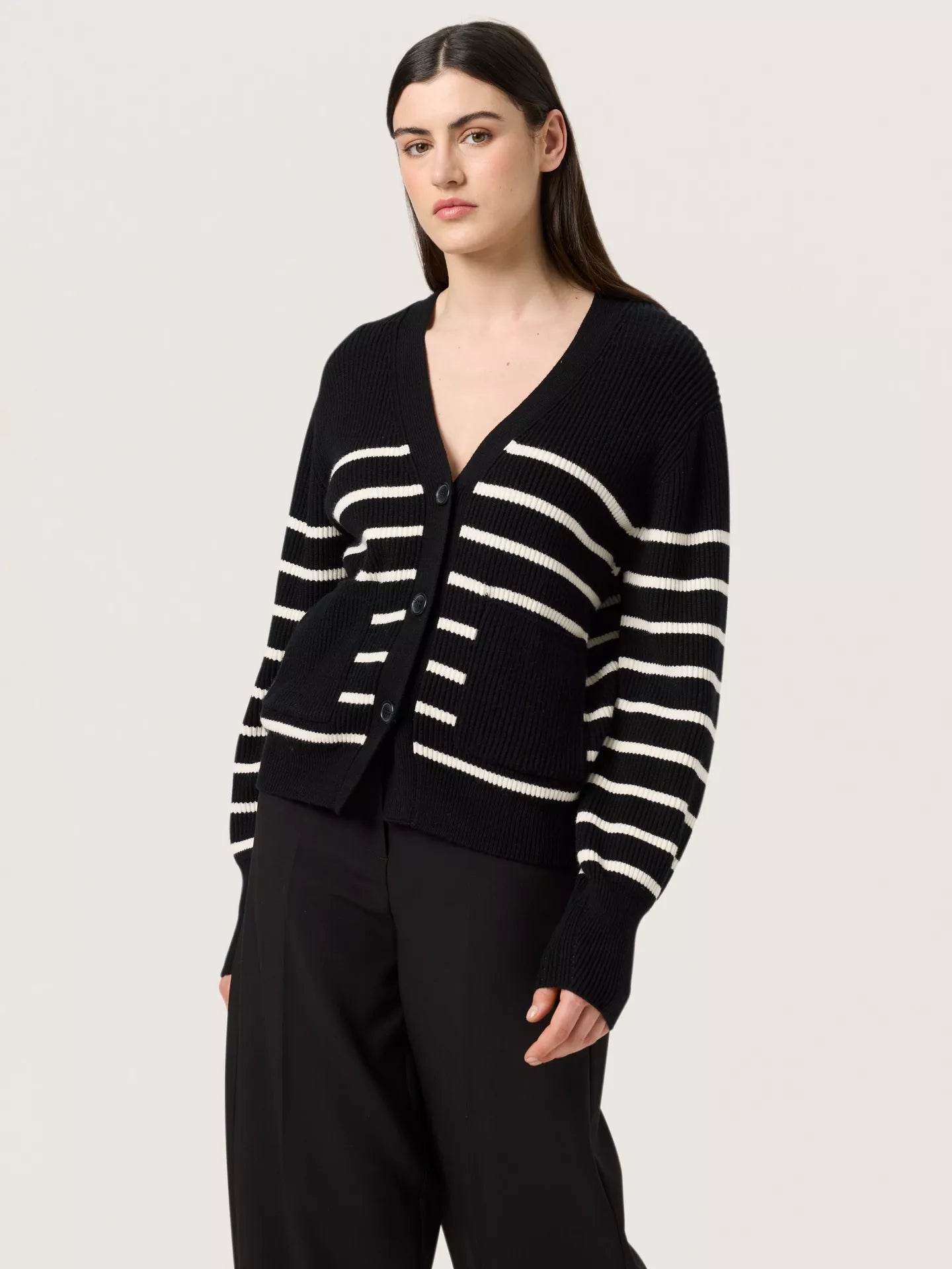 This beautiful Spina Cardigan is a modern twist on the classic black and white striped cardigan. Featuring the black block pockets and cuffs, along with the drop shoulder design, wide deep v-neck and casual button down front makes this such an easy piece. A simple throw on Cardigan  and paired with jeans. Easy. 

The Beach House Boutique, Rock, Cornwall. 
